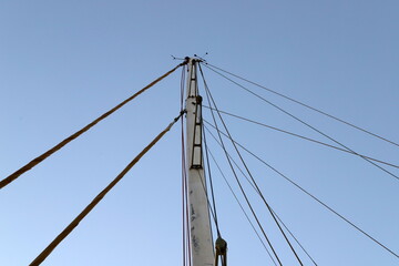 Masts in the port against the blue sky.