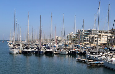 Fototapeta na wymiar Masts in the port against the blue sky.