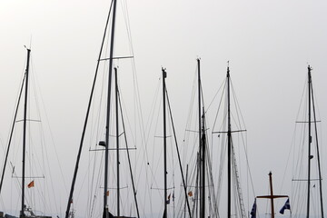Masts in the port against the blue sky.