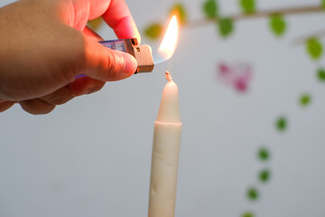 burning candle in hand