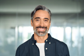 Happy middle aged 50 years old professional business man, smiling older executive manager, mature bearded businessman entrepreneur standing in office at work looking at camera, headshot portrait.