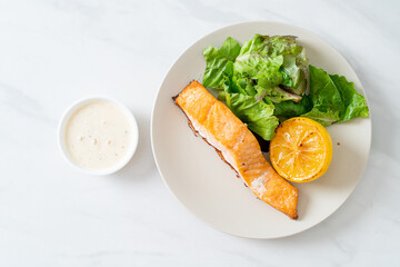fried salmon steak with lemon and vegetable