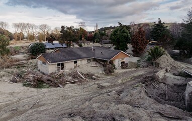 Silt and housing estate buried and damaged in the Cyclone Gabrielle natural disaster. Eskdale,...