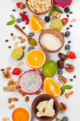 Assorted fresh fruits and nuts on a white background. Ingredients for a healthy dish
