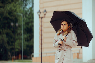 Woman Holding an Umbrella feeling Cold During Spring Season. Stressed person suffering from weather sensitivity feeling unwell 
