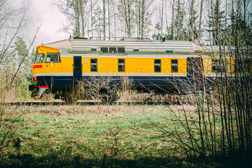 electric train on railway tracks in a forest environment in Latvia