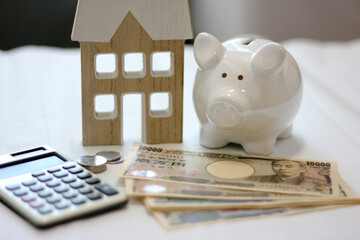 Fototapeta premium Real estate and finance concept with white piggy bank and Japanese money