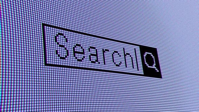 ディスプレイモニターに映し出される「Search」の文字クローズアップ。