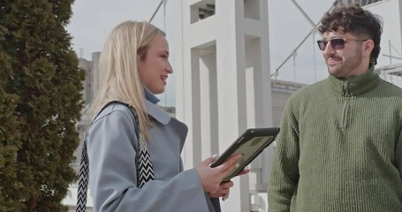 Business associates are working remotely, discussing reports on a tablet, addressing project issues, and brainstorming possible solutions, highlighting their adaptability and problem solving skills.