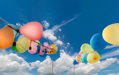 Rows of multicolored  balloons in the sky.