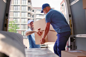 Male Movers In Uniform Loading Delivery