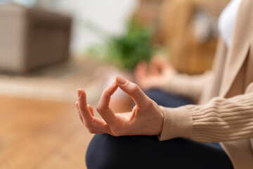 close up of  hand of woman sitting on the floor and doing yoga and relaxing exercise  Healthy...