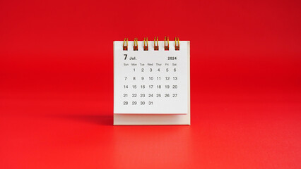 Month of July 2024 calendar on a red background with copy space