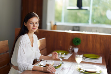 Romantic Dinner Date at Home Woman Smiling in Ecstasy at Elegant Dining Table with Delicious Homemade Food and Wine Joyful Celebration of Love and Happiness