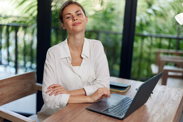 Working from Home Happy Freelancer Woman Typing on Laptop in Cozy Bali Workspace with Summery Interior or Smiling Businesswoman Working Online Female Freelancer at Home Office in Bali, Typing and