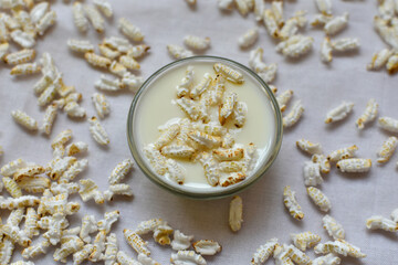 Muri Khoi or Puffed Rice Popped Rice Traditional Bengali Indian Dry Snack with milk for Puja and...