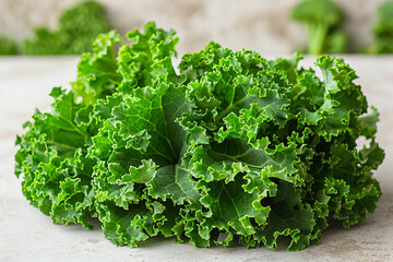 A bundle of fresh green kale leaves, their curly edges glowing against a clean, bright background, promising nutrient-rich goodness and earthy flavor.