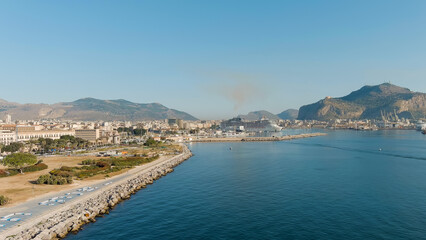 Palermo, Sicily, Italy. A large cruise ship is moored in the port of Palermo. Lots of smoke from...