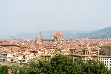 Florence, Italy. Santa Maria Del Fiore. The 13th-century cathedral, famous for its red-tiled dome, colorful marble facade and Giotto's bell tower. Panorama of the city. Summer day - obrazy, fototapety, plakaty