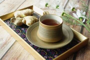 Ginger tea on wooden background.