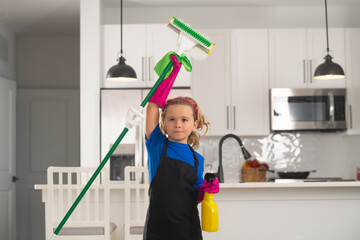 Housekeeping, home chores. Portrait of child helping with housework, cleaning the house....