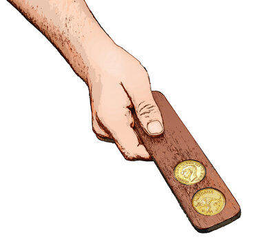 Hand holding a two up paddle with Australian pennies. Anzac Day
