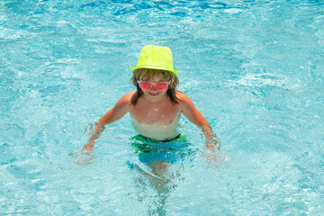 Child in swimming pool, healthy outdoor sport activity for children. Kids beach fun. Fashion summer...