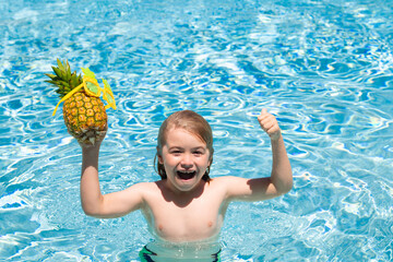 Child playing in the swimming pool. Summer kids activity. Little child playing in blue water. Summer pineapple fruit for children.