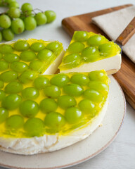 Cheesecake with grapes on a sponge cake base.
