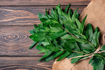 Fresh mint leaves on wooden background. Top view. Copy space.