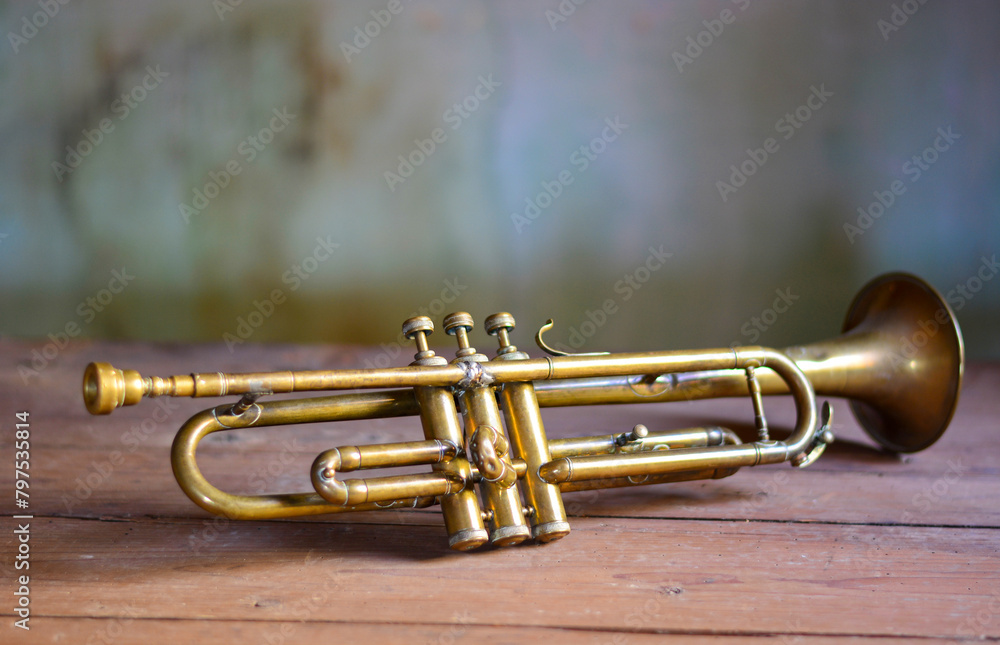 Poster an antique jazz trumpet on an antique brown wooden table