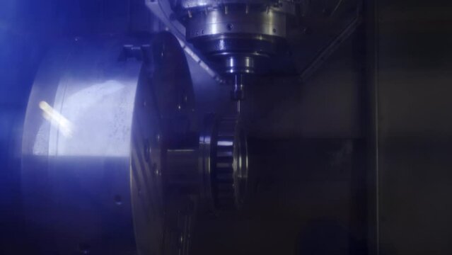 Precision CNC machine carves metal part in industrial workspace. Automated process shapes component on lathe with turn, mill functions. Manufacturing equipment in action, produce complex parts.