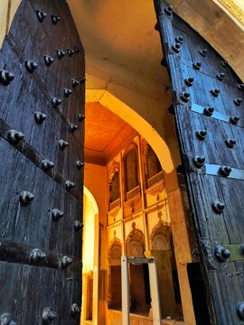 The interior of a mughal architecture building through the giant entrance gate.