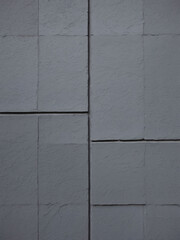 Exterior slate gray concrete pattern wall building.