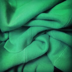 Grüner geknautschter Pullover als  Hintergrund Textur