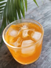 Orange soft drink and ice cubes