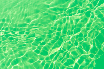 Green water waves on the surface ripples blurred. Defocus blurred transparent blue colored clear...