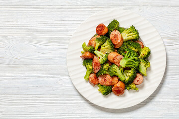 fried juicy sausage and crispy broccoli on plate