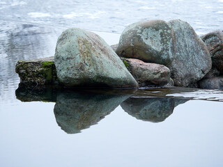 old stones reflected in the water