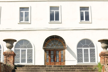 Wooden central entrance in an old white building