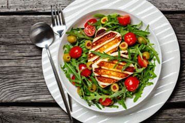salad with grilled halloumi greek cheese in bowl