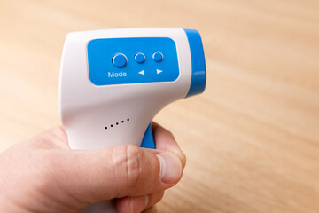 Remote thermometer with settings for measuring human body temperature.