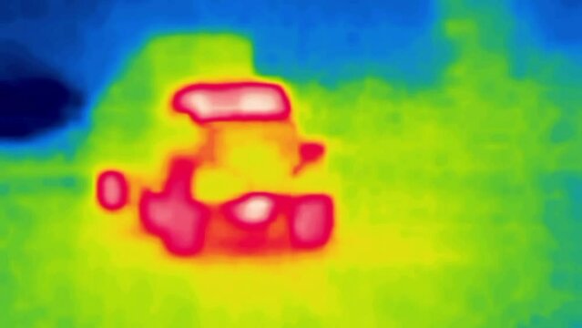 Trucks overcome the ascents and descents, serpentine and turnpike. Hard way racy expressions. Yamal highway, Siberia. Thermal imager device.