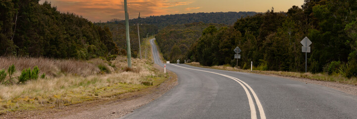 Sunset On Savage River Road Tarkine Tasmania With Road disappearing into distance 