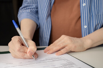 Pregnant woman signing a contract for medical care during pregnancy, maternal health services, and...