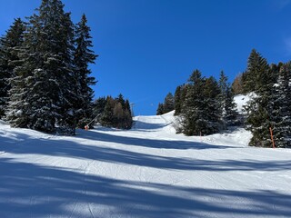 Amazing sport-recreational snowy winter tracks for skiing and snowboarding in the area of the tourist resorts of Valbella and Lenzerheide in the Swiss Alps - Canton of Grisons, Switzerland (Schweiz)