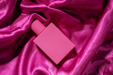 Rose perfume on pink silk, elegant glass bottle, luxury fragrance, feminine beauty