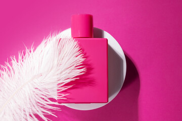 Pink perfume on the podium with soft feather, elegant glass bottle, luxury fragrance, feminine...