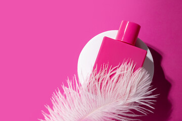 Pink perfume on the podium with soft feather, smooth liquid, softness in a bottle, sensual...