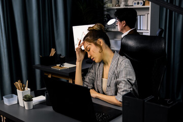 Businesswoman working on desk with stretching arm up and down manner with body health ache of...